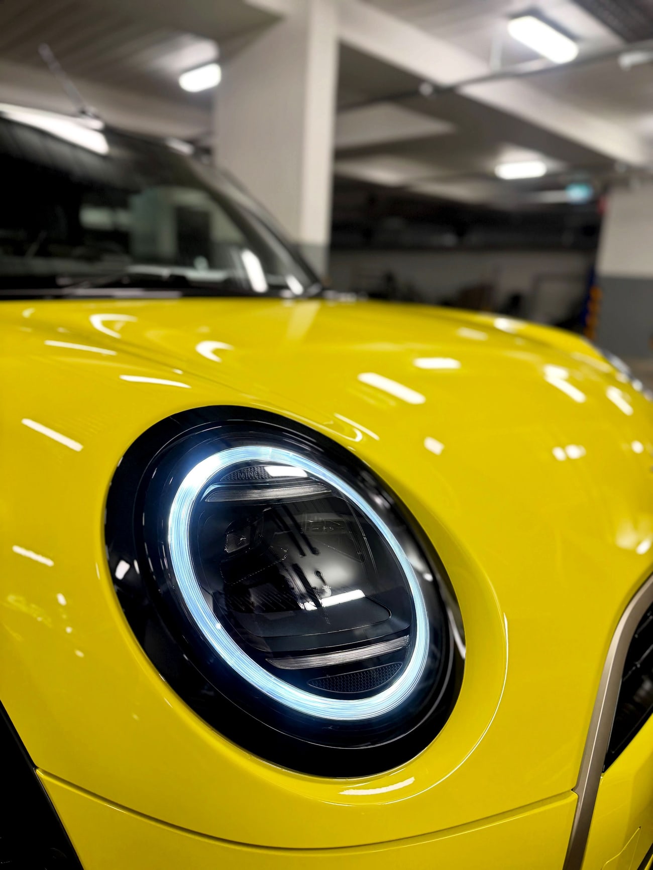 A bright yellow car detailed to a mirror finish
