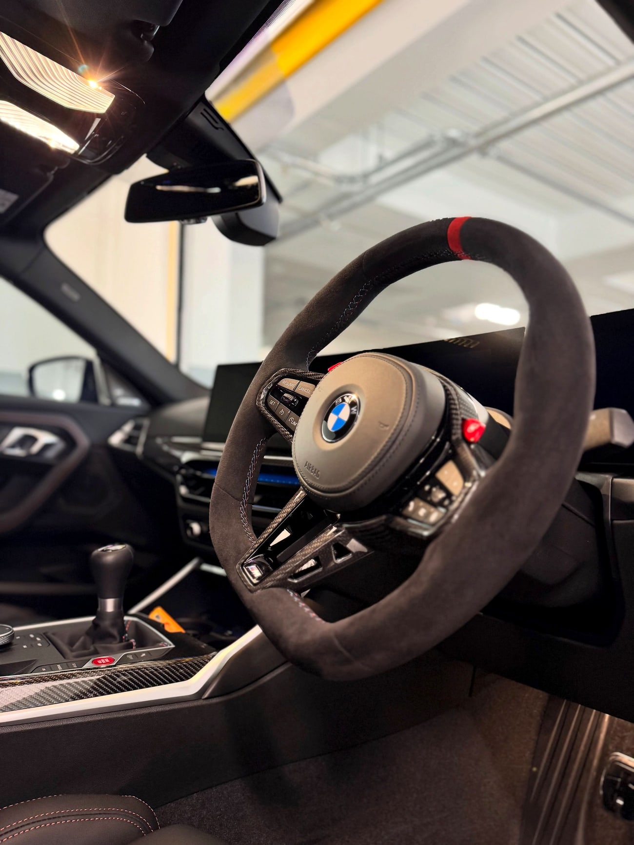 A detailed car interior with clean leather, trim and steering wheel