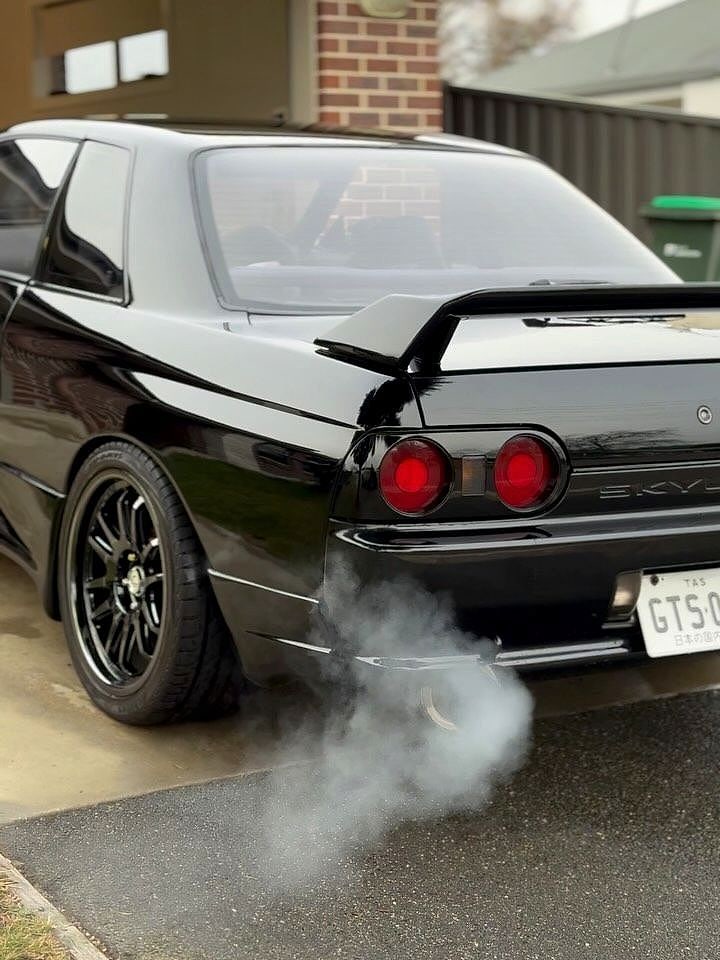 A black Nissan Skyline R32 after a paint correction and ceramic coat